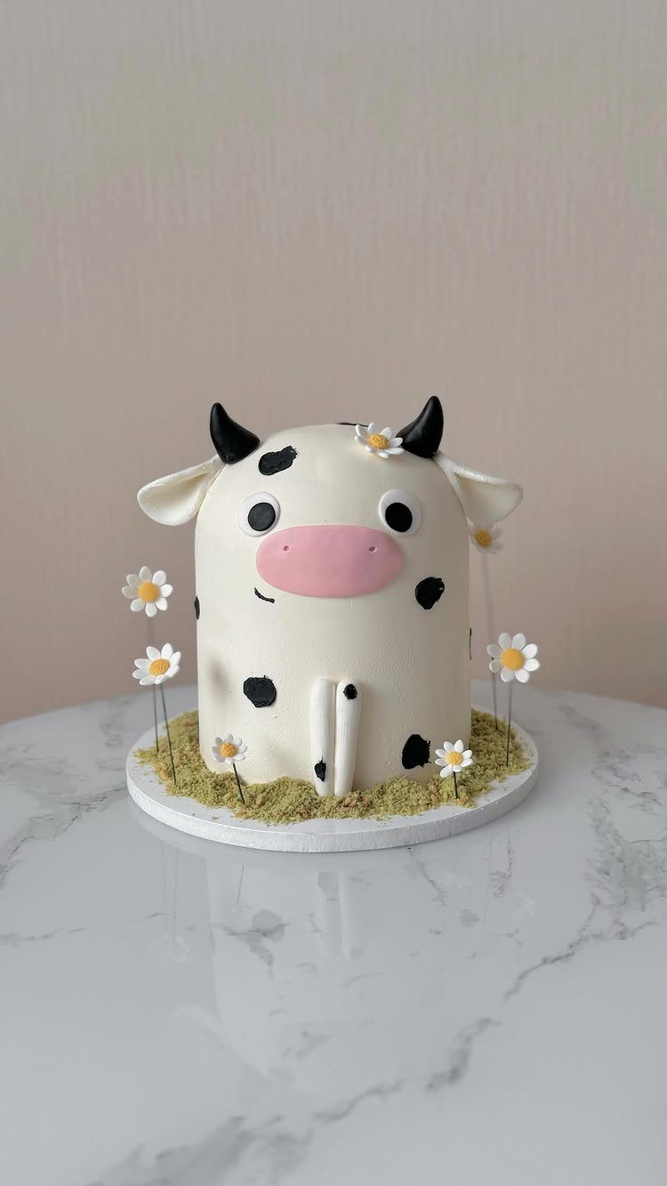 21 Cake Decoration Ideas for Every Skill Level 8 Cow face cake with black spots and white daisies on a marble table