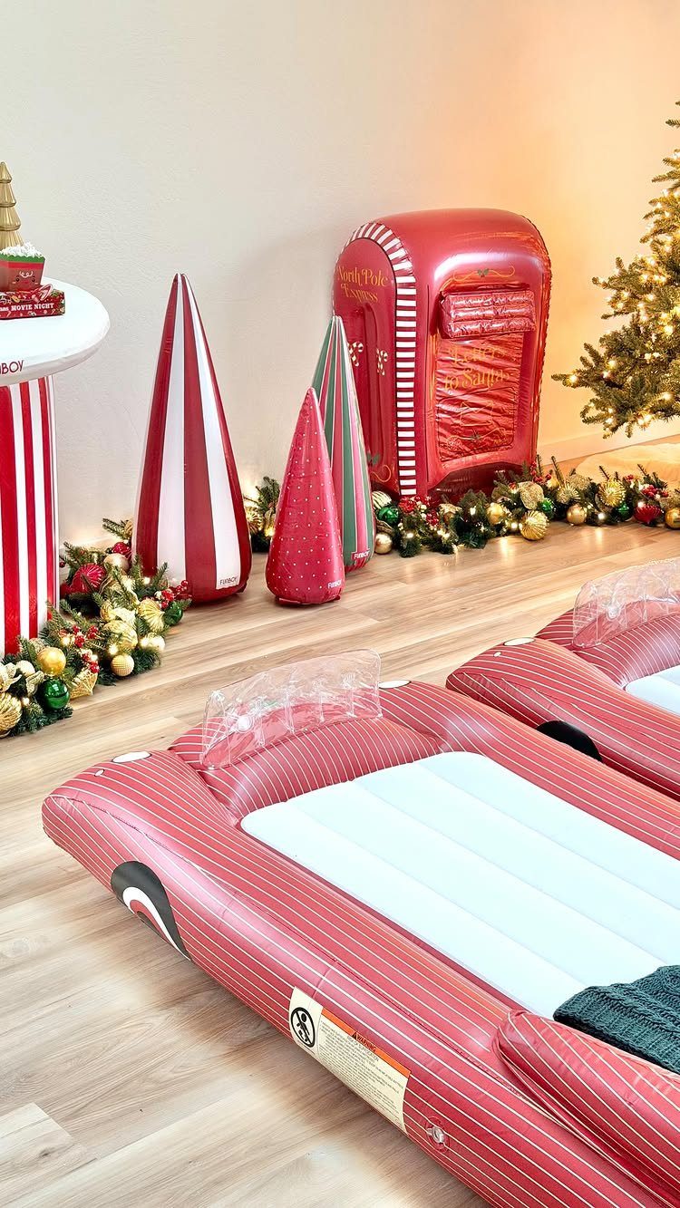 22 Christmas Party Themes for Adults Ideas (2026) 22 Christmas party decorations featuring red and white striped inflatables and a red mailbox.