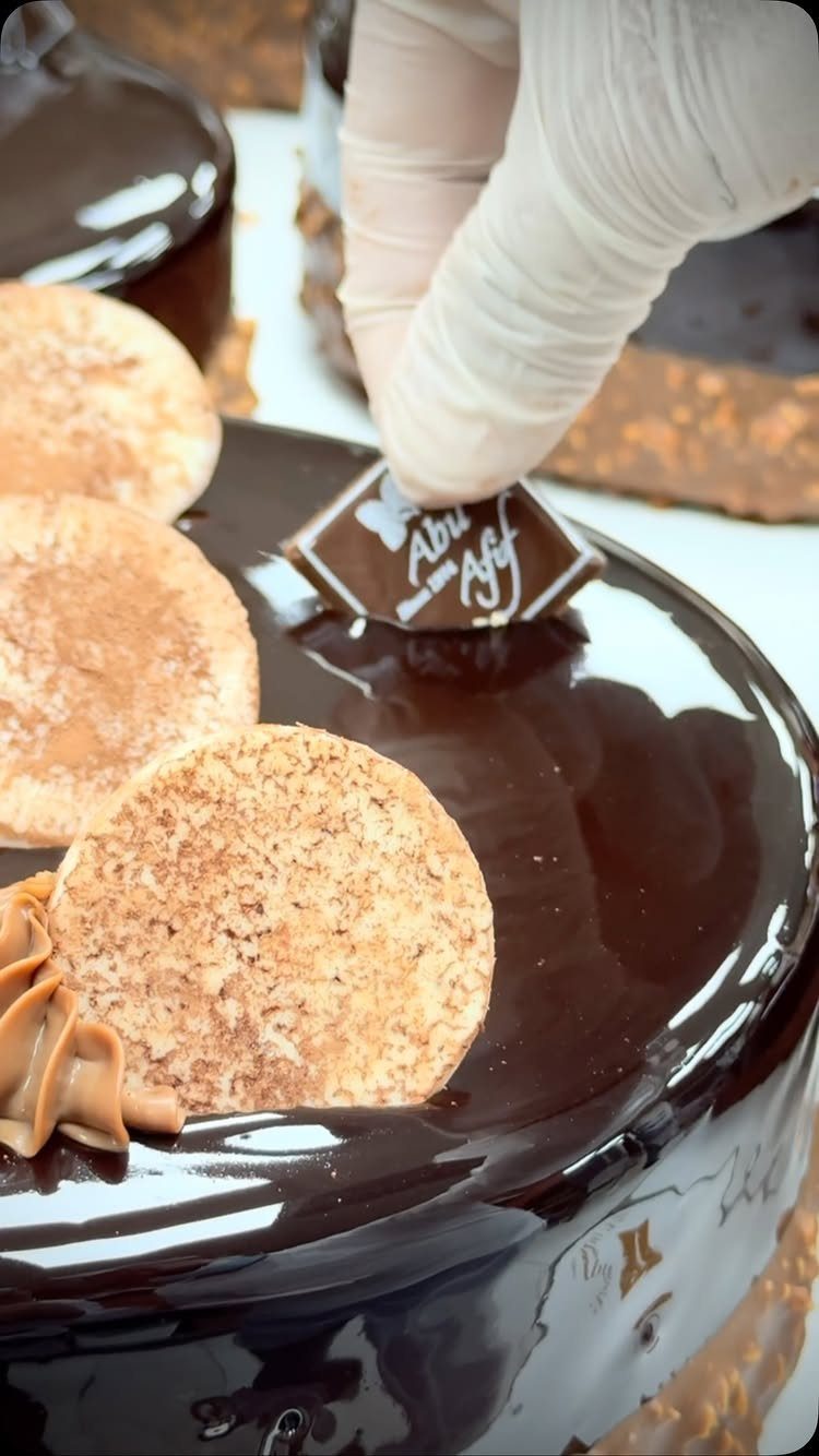 21 Cake Decoration Ideas for Every Skill Level 13 Chocolate glazed cake topped with round cookies and a small chocolate plaque.