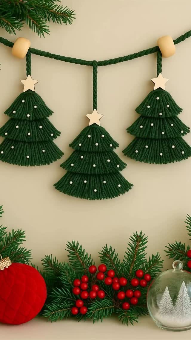 36 Christmas Decor Ideas for the Home: Doors, Tables, Trees & More 12 Green yarn Christmas tree decorations hanging above pine branches and red berries.