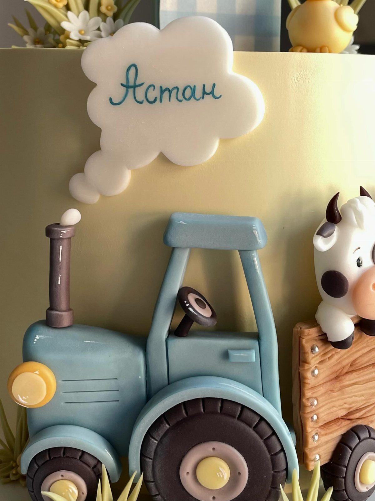 Animal Themed Birthday Cake: 9 Party Designs from Farm to Fantasy 5 Yellow cake decorated with a blue fondant tractor and a small cow.