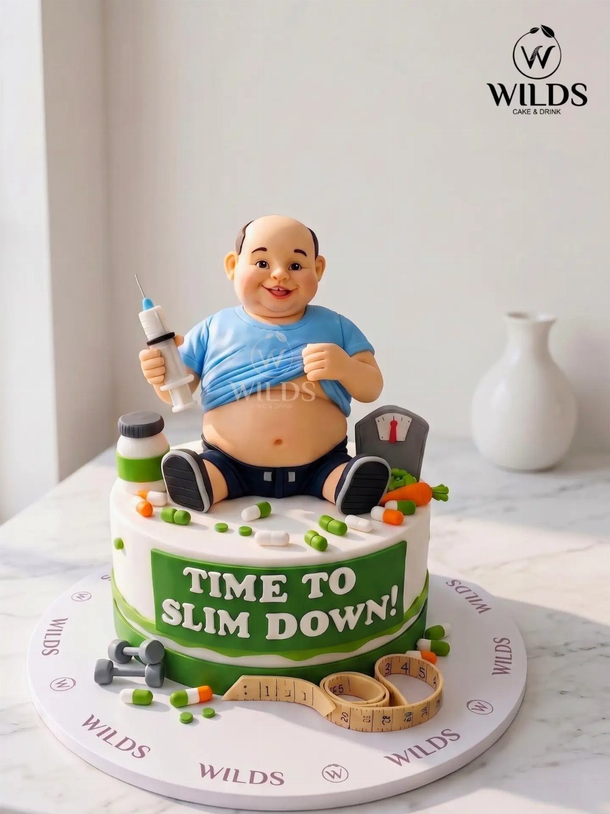 19 Funny Cake Designs That Steal the Whole Party 12 Cake with a figure of an overweight man and a slim down banner.