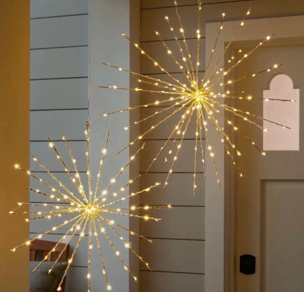 36 Christmas Decor Ideas for the Home: Doors, Tables, Trees & More 17 Two gold starburst lights with warm LEDs hanging by a white door.