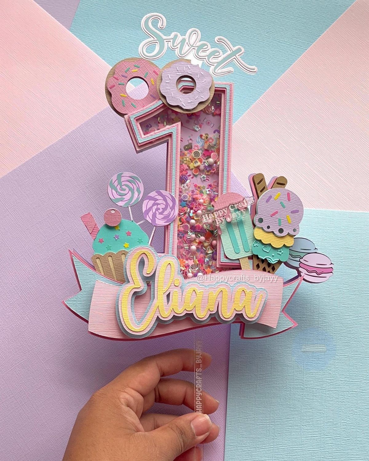 21 Cake Decoration Ideas for Every Skill Level 9 Personalized cake topper with name Eliana, number one, and colorful candy decorations.