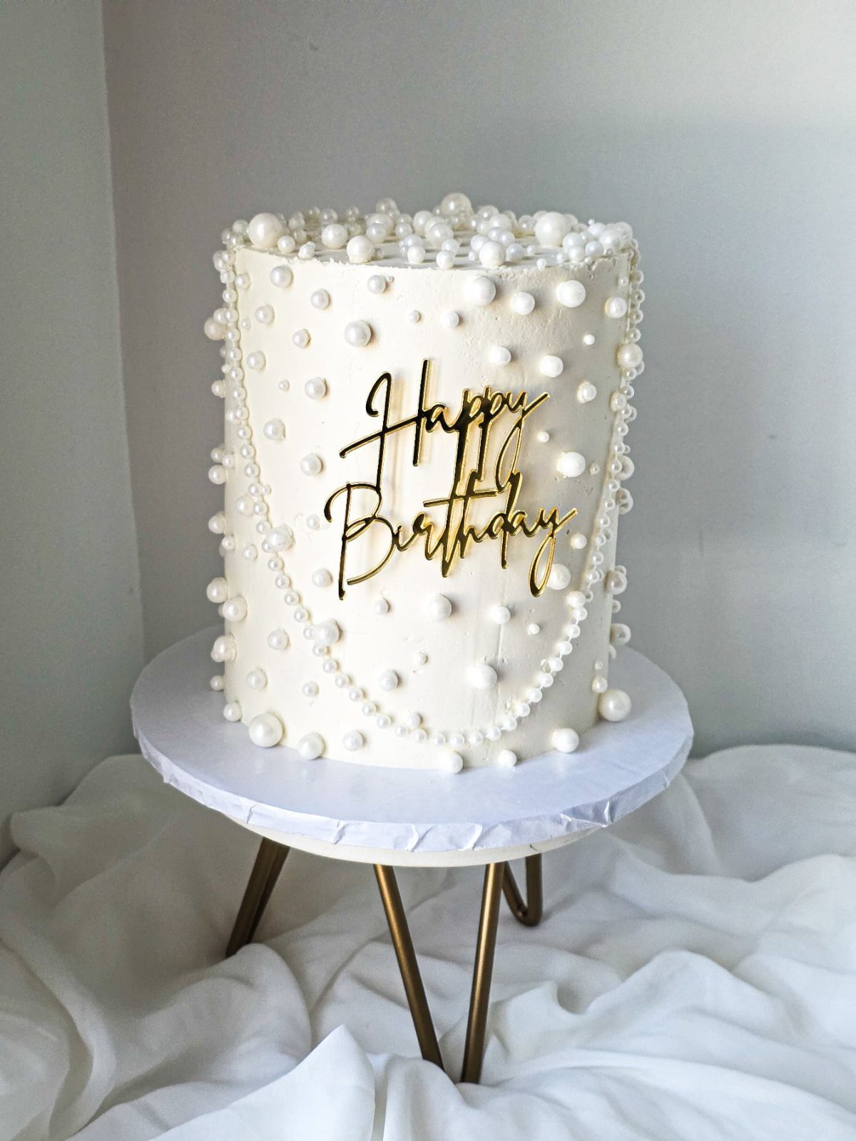 21 Cake Decoration Ideas for Every Skill Level 7 White frosted birthday cake decorated with white sugar pearls and gold topper.