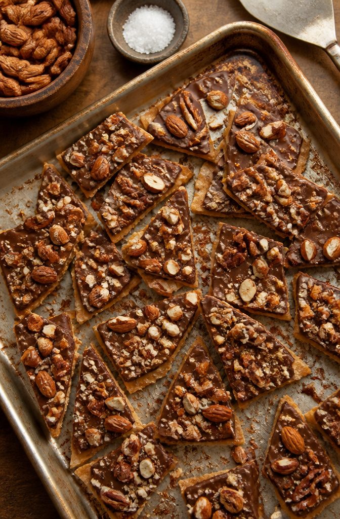 A close-up of graham cracker bark topped with nuts.